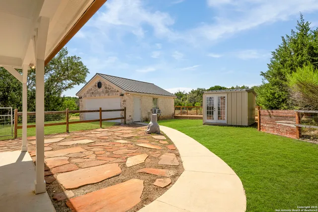 a view of backyard of house and car parked