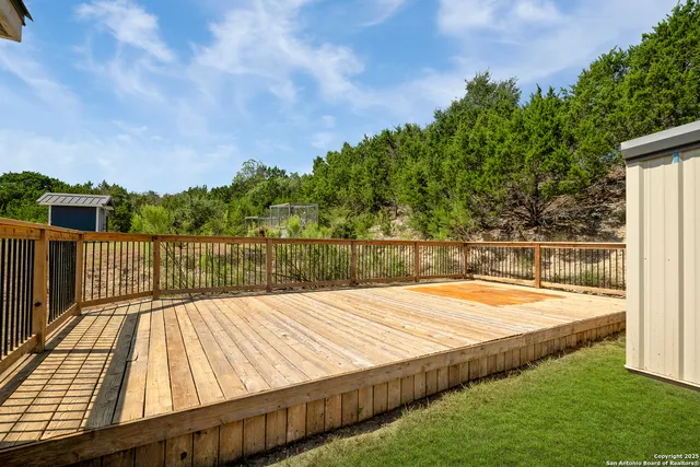 a view of a backyard with wooden floor and lake view