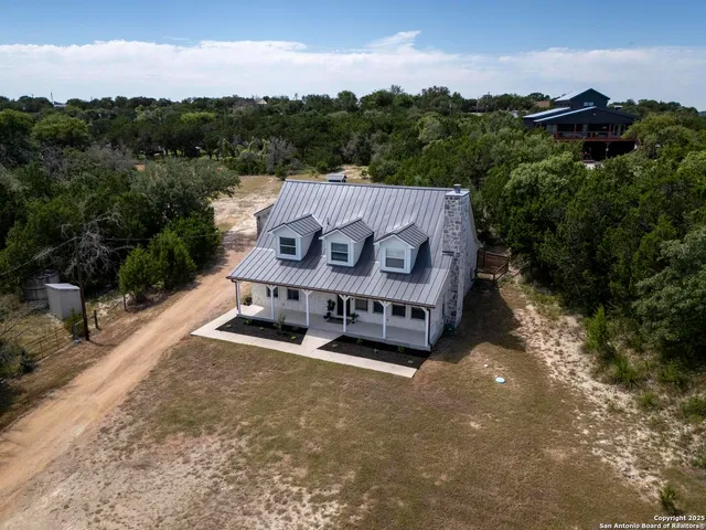 a view of a park with furniture and a garden