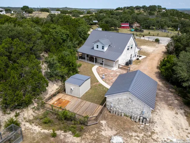 an aerial view of a house with a yard