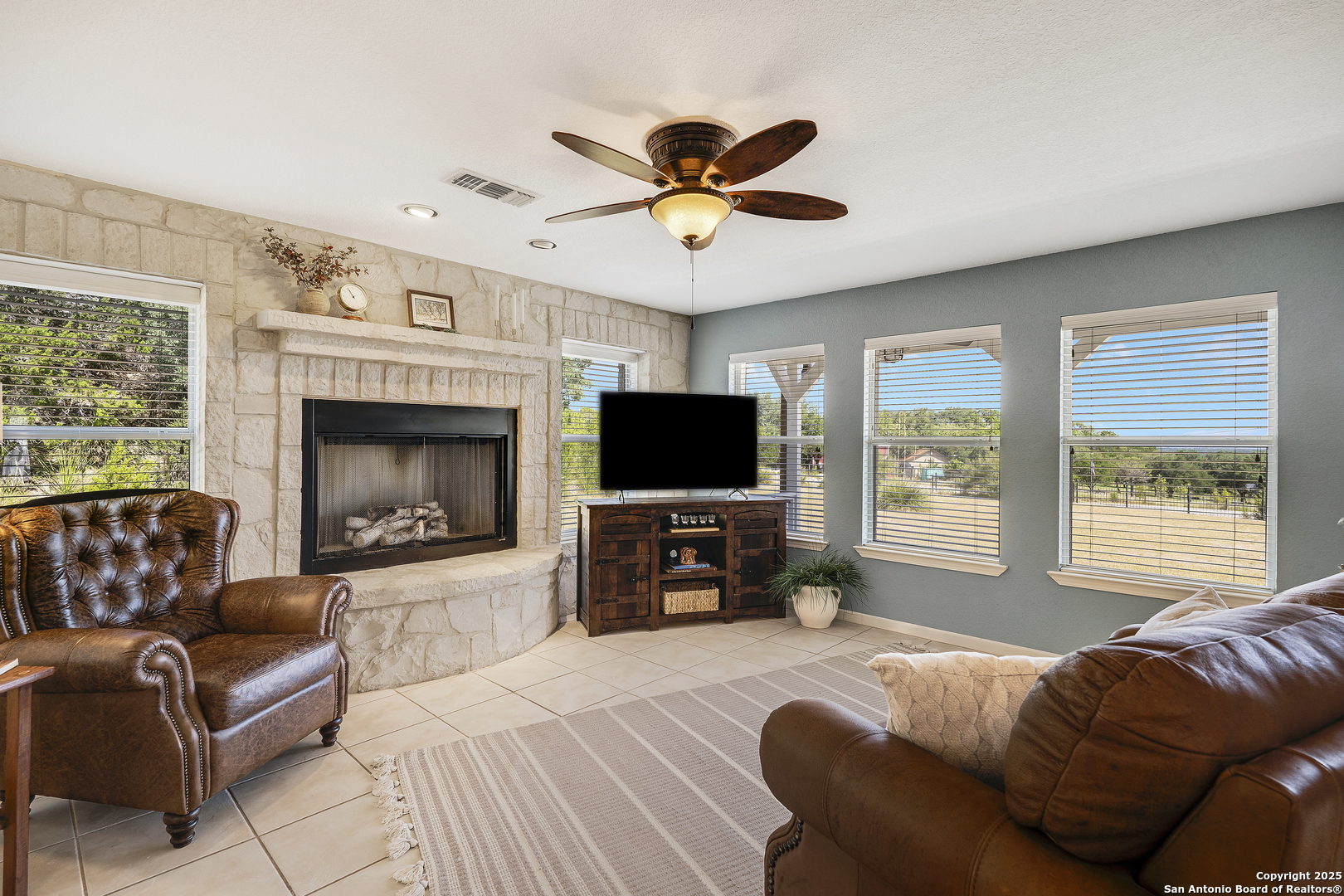 107 Ridge View Drive Boerne, TX 78006 - Photo 4 of 53 a living room with furniture a flat screen tv and a fireplace