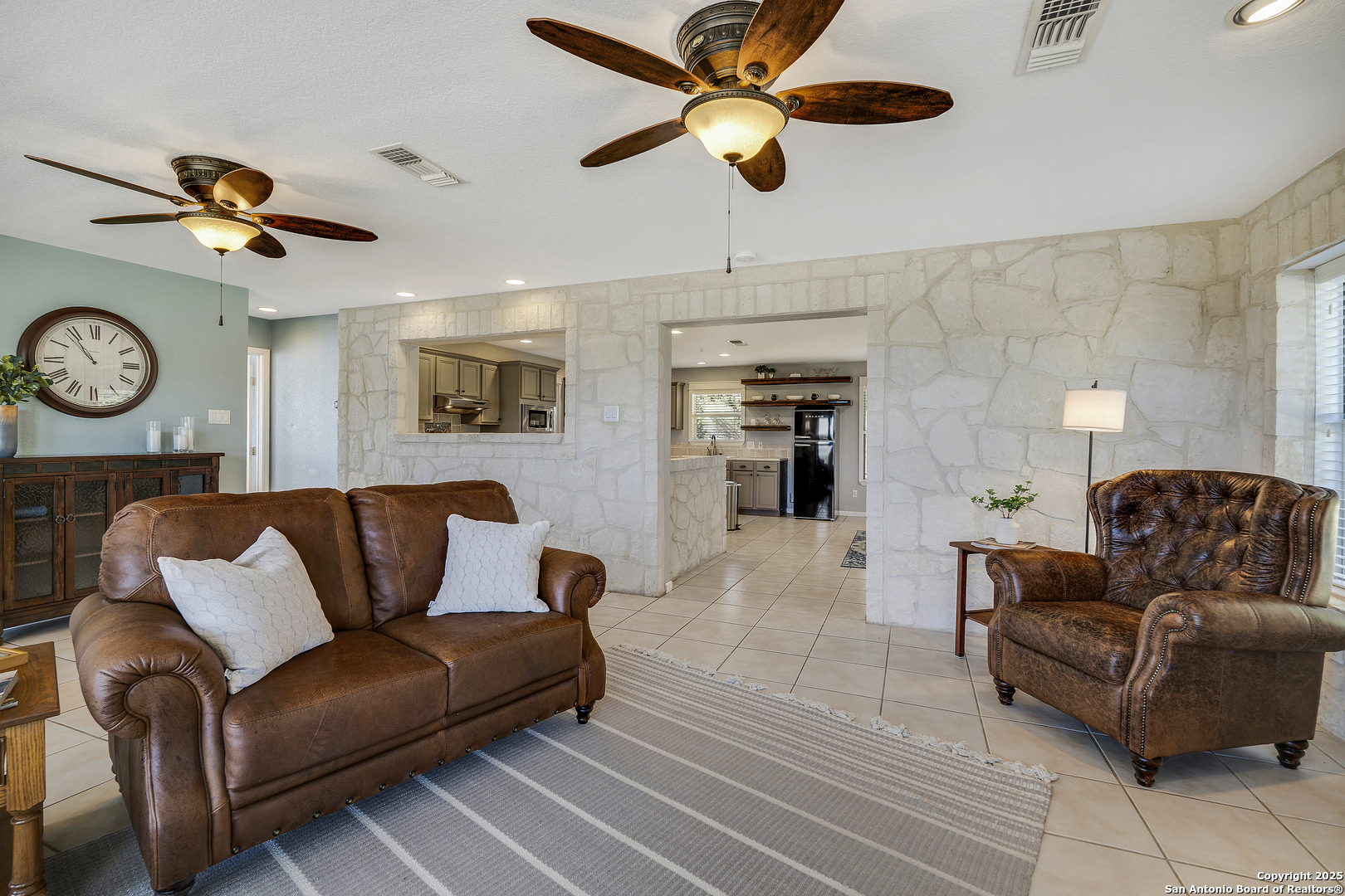 107 Ridge View Drive Boerne, TX 78006 - Photo 6 of 53 a living room with furniture a clock and a ceiling fan