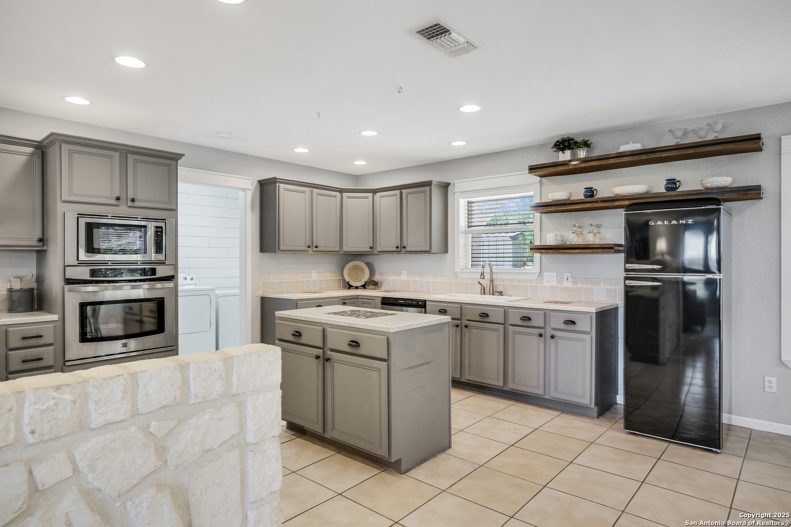 107 Ridge View Drive Boerne, TX 78006 - Photo 8 of 53 a kitchen with stainless steel appliances granite countertop a stove top oven a sink and a refrigerator