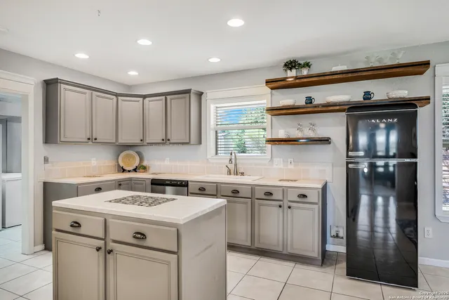 a kitchen with a sink cabinets and stainless steel appliances