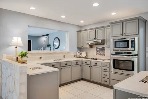 a kitchen with a sink stove and microwave