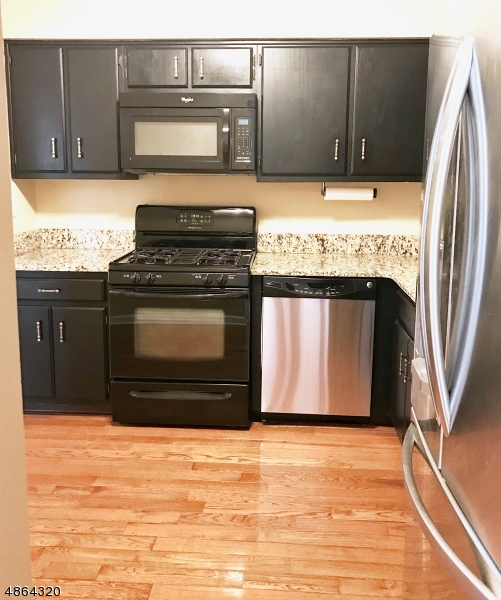 125 Patriots Road Morris Plains, NJ 07950 - Photo 7 of 12 a kitchen with stainless steel appliances granite countertop a stove and a refrigerator