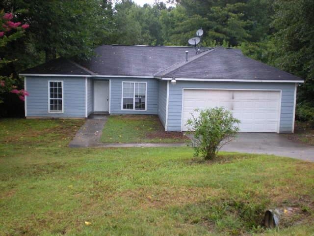 a aerial view of a house with a yard and a garage