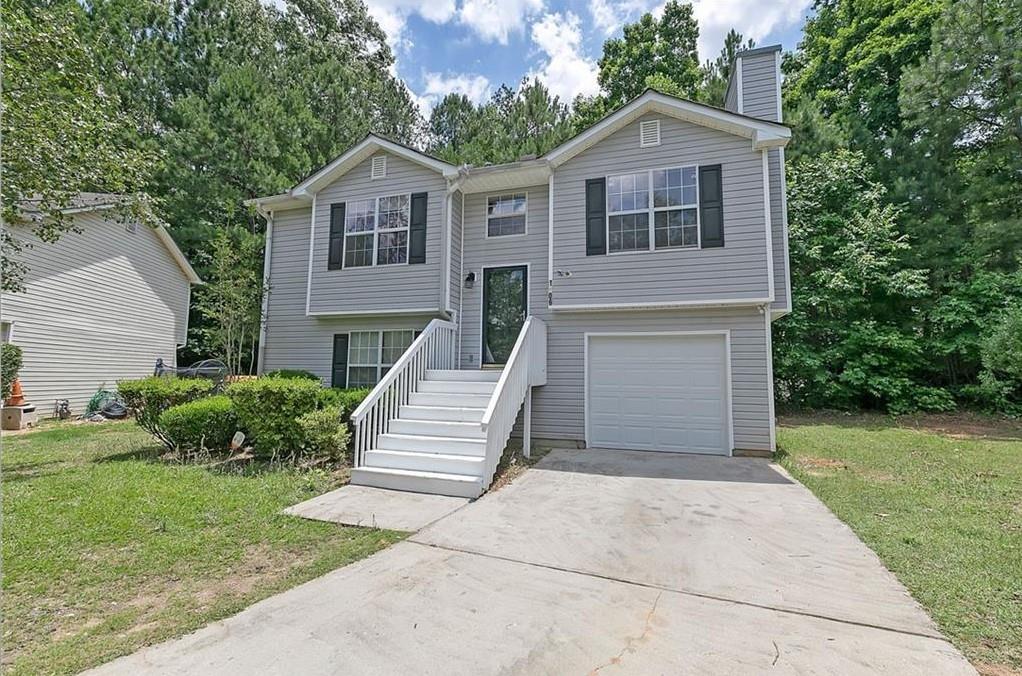 1506 Norman Crossing Atlanta, GA 30349 - Photo 1 of 1 a front view of a house with a yard and trees