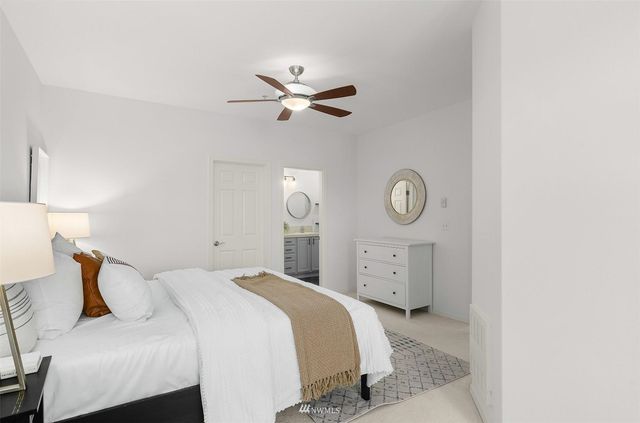 a view of a city street with a car parked on the side of the road