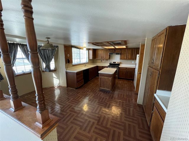a room with chairs a washer and dryer