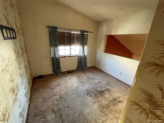 a view of an empty room with windows