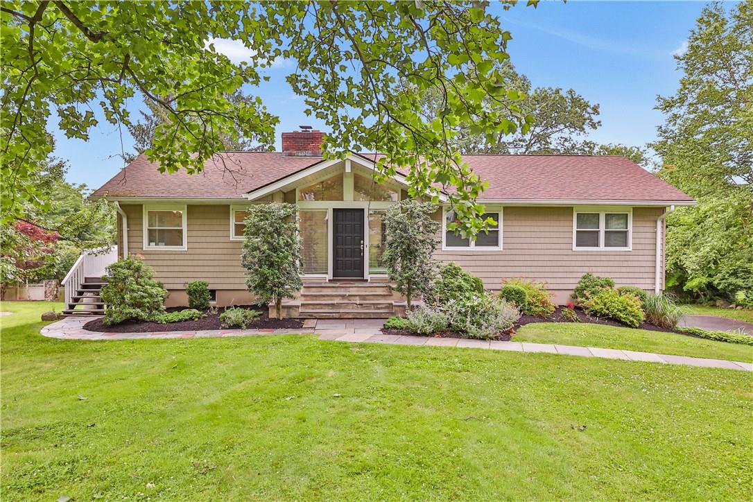 83 Byram Ridge Road Armonk, NY 10504 - Photo 1 of 1 a front view of a house with a garden and yard