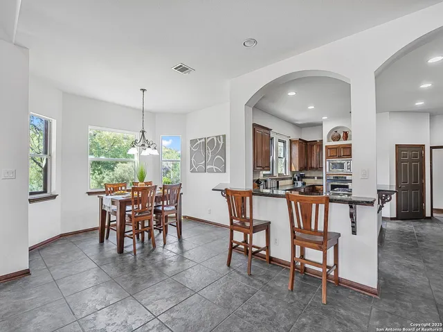 a dining room with furniture and window