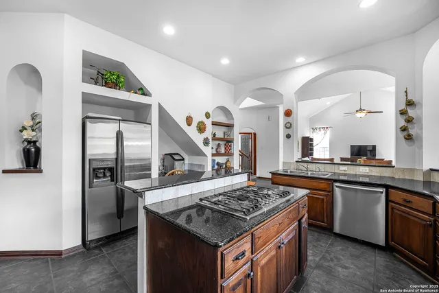 a kitchen with stainless steel appliances granite countertop a stove and a sink