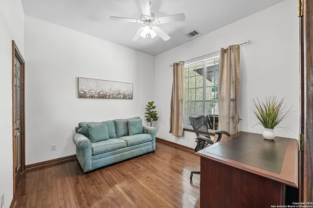 a living room with furniture potted plant and window