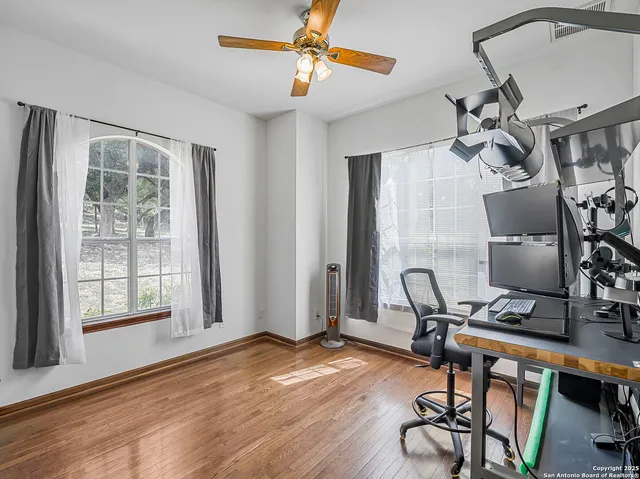 a view of a workspace with furniture and a window