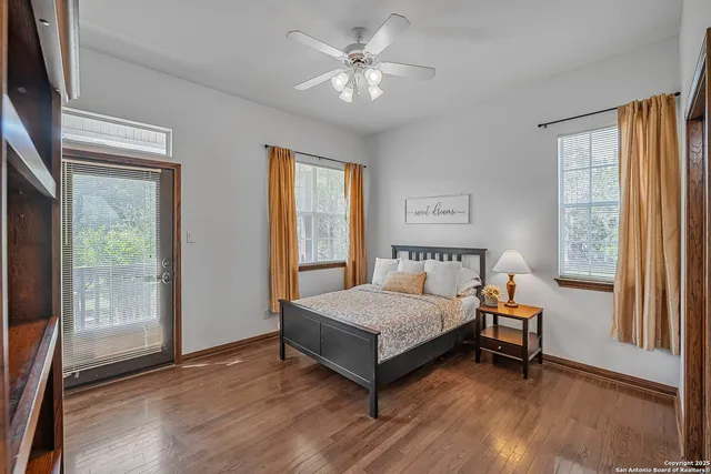 a bedroom with a bed and a large window with outer view