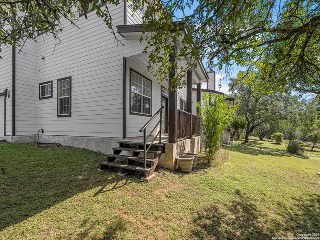 a backyard of a house with barbeque oven