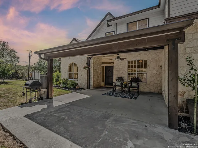 a view of a house with patio furniture and a fireplace