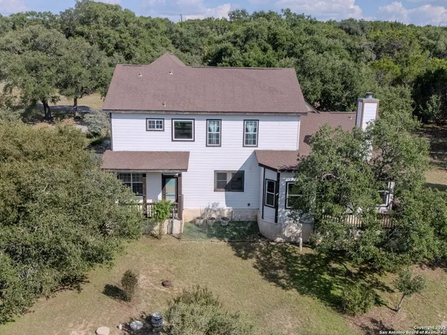 a aerial view of a house yard and trees