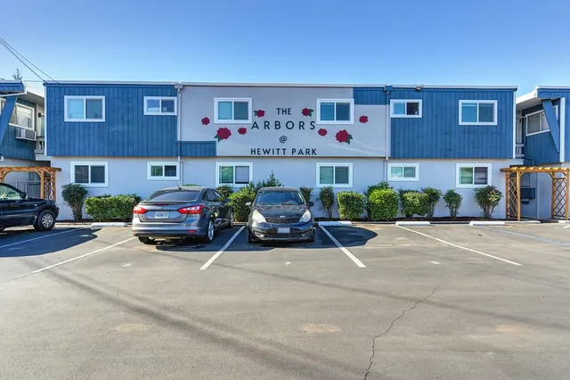a view of a cars park in front of a building