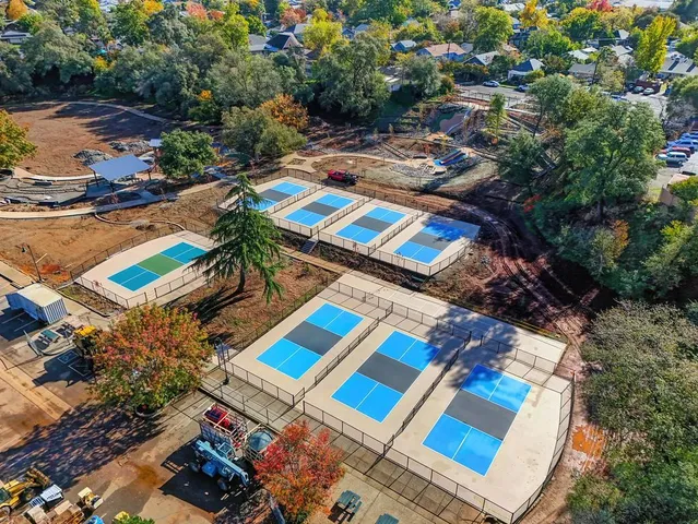 an aerial view of residential houses with outdoor space