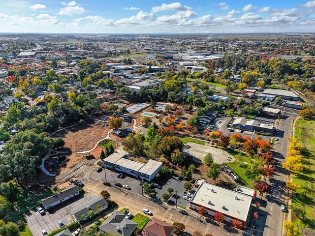 an aerial view of a house with a yard and lake view