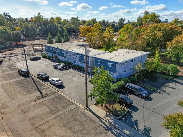 a view of a room with an empty space and wooden floor
