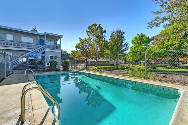 an aerial view of residential houses with outdoor space