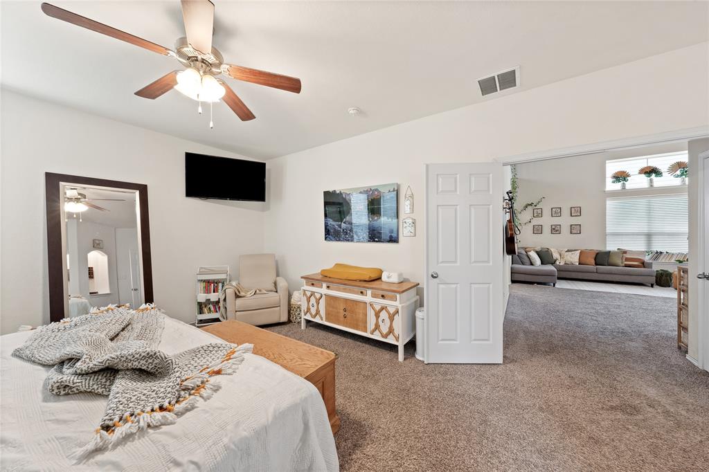 5516 Pinery Drive Waco, TX 76708 - Photo 14 of 30 a spacious bedroom with a bed a couch and a chandelier