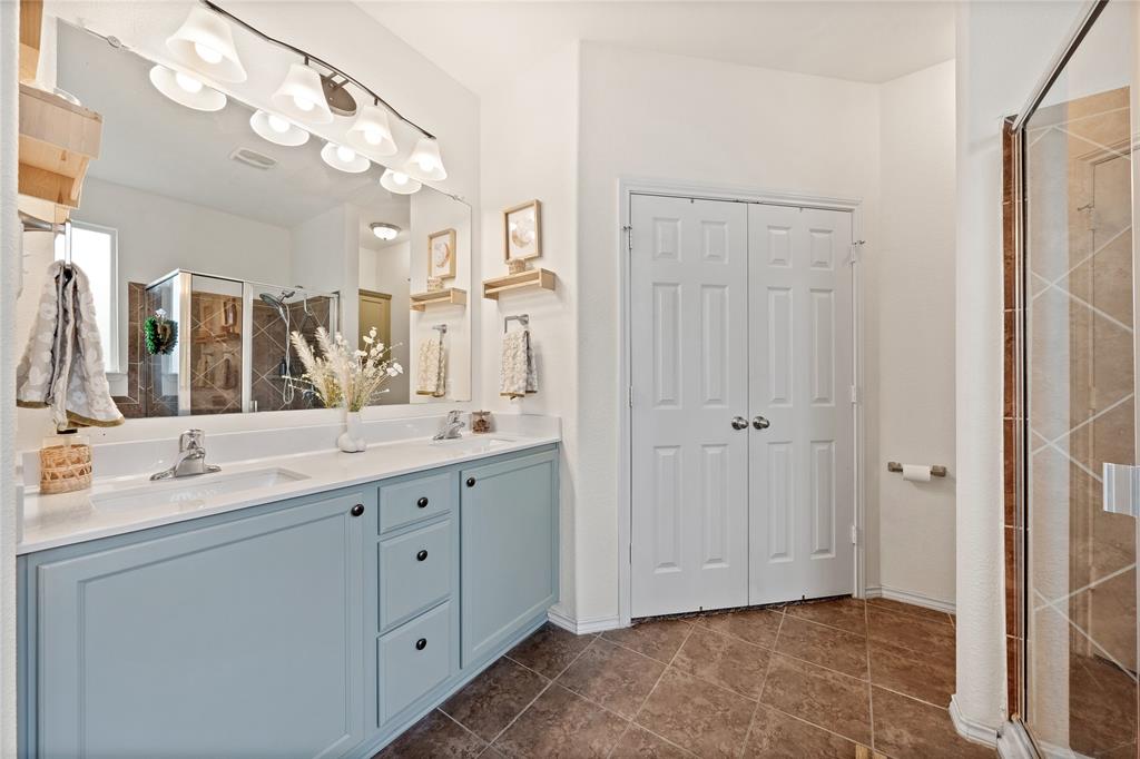 5516 Pinery Drive Waco, TX 76708 - Photo 15 of 30 a spacious bathroom with a granite countertop sink a mirror and a shower