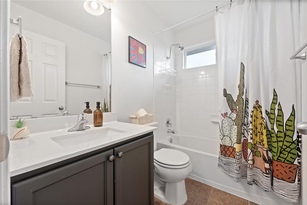 5516 Pinery Drive Waco, TX 76708 - Photo 20 of 30 a bathroom with a sink a toilet and shower