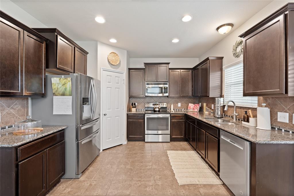 5516 Pinery Drive Waco, TX 76708 - Photo 2 of 30 a kitchen with stainless steel appliances granite countertop a refrigerator stove and sink