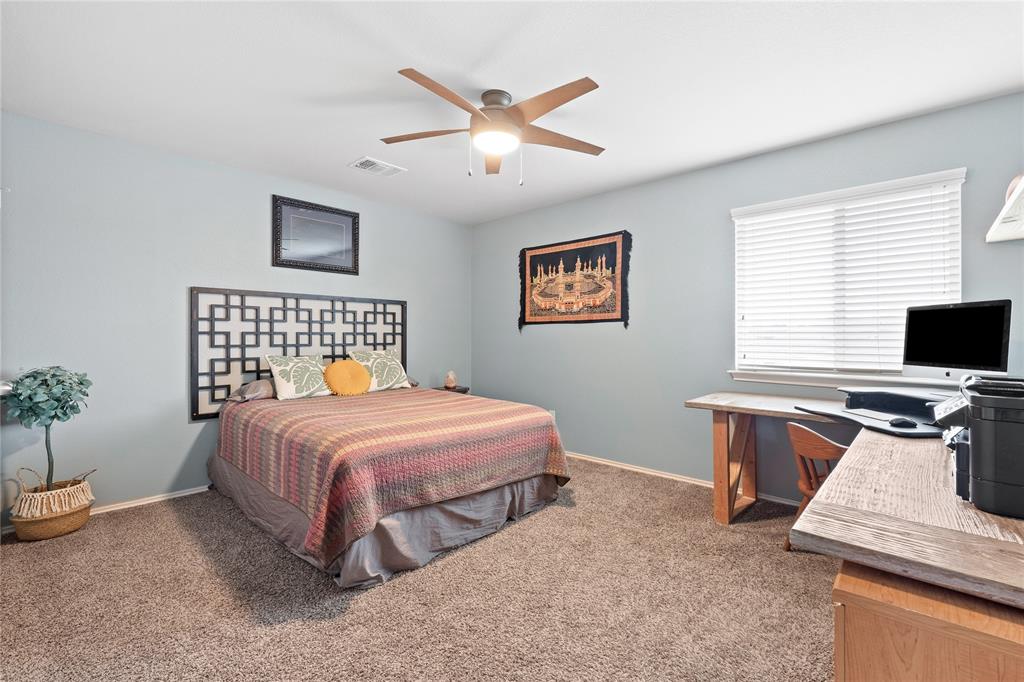 5516 Pinery Drive Waco, TX 76708 - Photo 21 of 30 a bedroom with a bed and a table