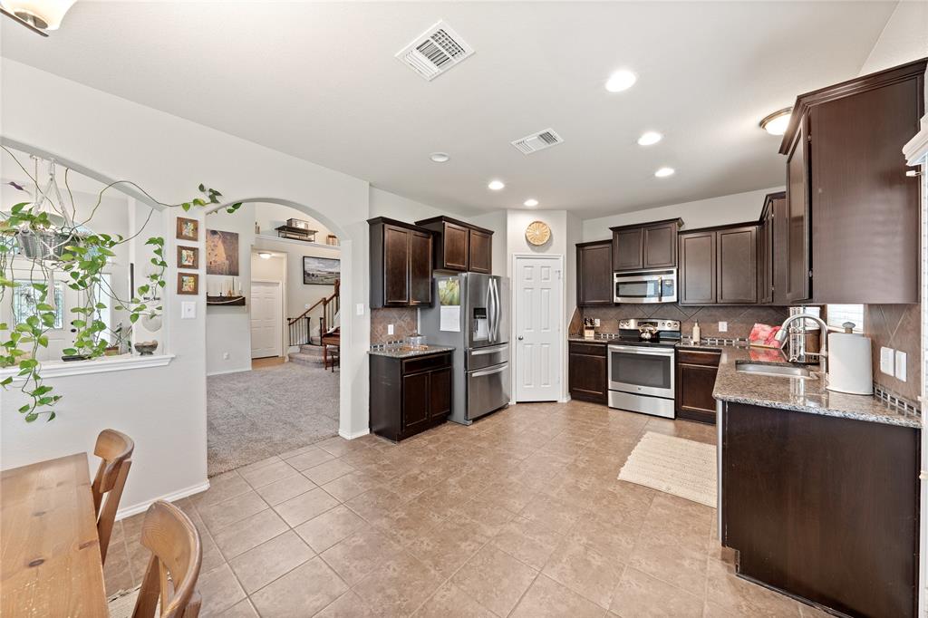 5516 Pinery Drive Waco, TX 76708 - Photo 5 of 30 a kitchen with stainless steel appliances a refrigerator sink and microwave