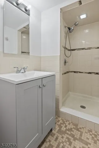 a bathroom with a shower sink and mirror