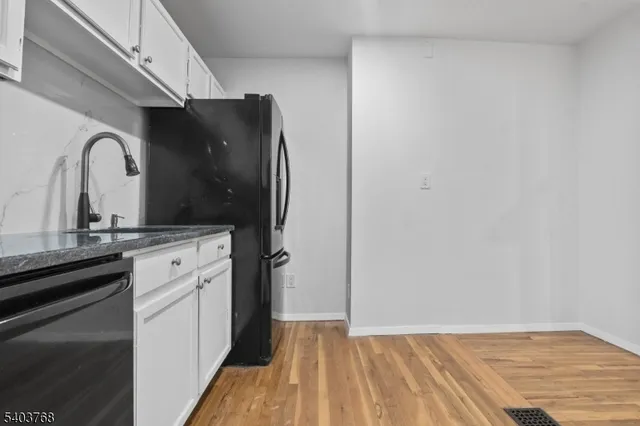 a kitchen with a sink and refrigerator