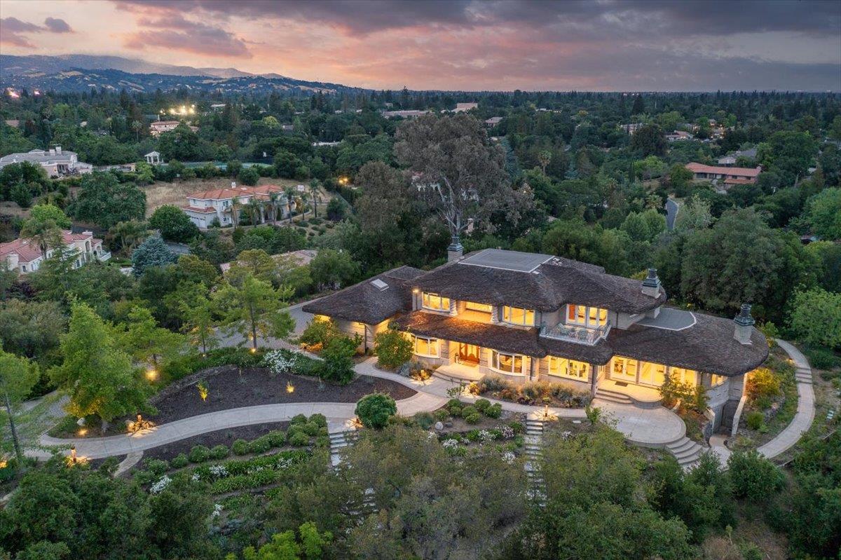 an aerial view of residential houses with outdoor space and trees