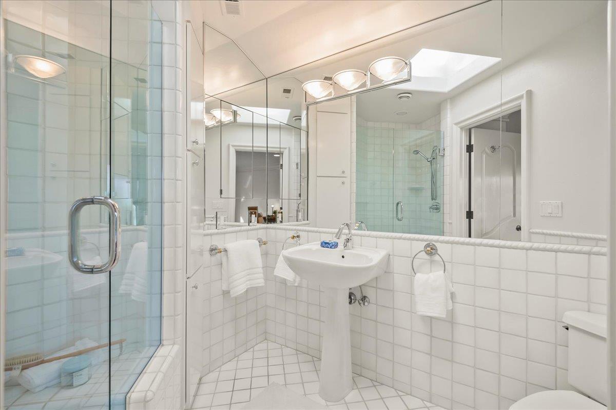 14467 Sobey Road Saratoga, CA 95070 - Photo 34 of 61 a bathroom with a double vanity sink mirror and shower