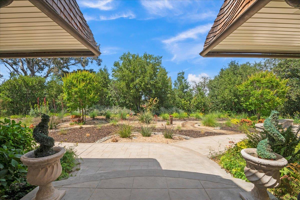 14467 Sobey Road Saratoga, CA 95070 - Photo 49 of 61 a white house with a yard and plants in front of it