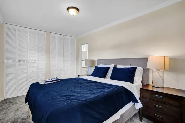 a bedroom with a bed and a night stand