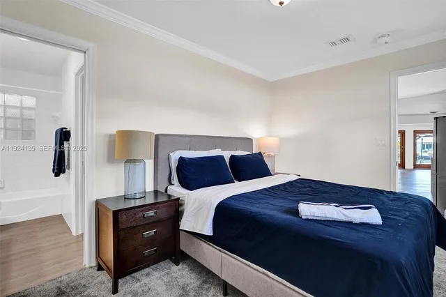 a bedroom with a bed and a night stand