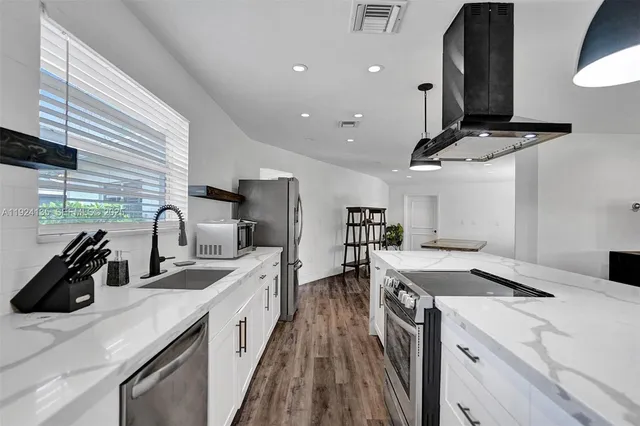 a kitchen that has a sink and a stove