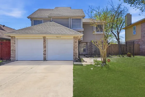 a front view of house with a garden