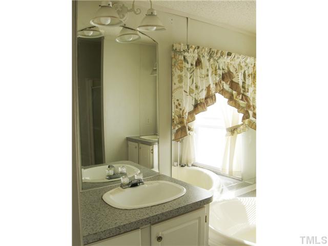 1601 Morgan Road Benson, NC 27504 - Photo 11 of 25 Master bath has double vanities, garden tub, and separate shower.