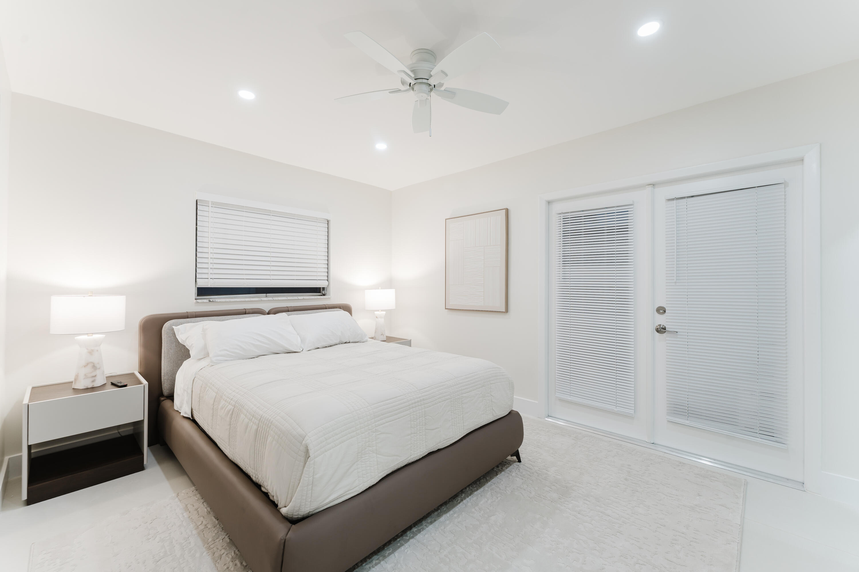 3199 Northeast 6th Drive Boca Raton, FL 33431 - Photo 38 of 49 a bedroom with a bed and a chandelier