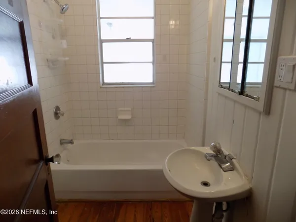 a bathroom with a sink a bathtub and a shower