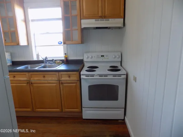 a kitchen with a stove and cabinets