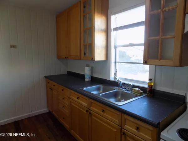 a kitchen with a sink cabinets and a window