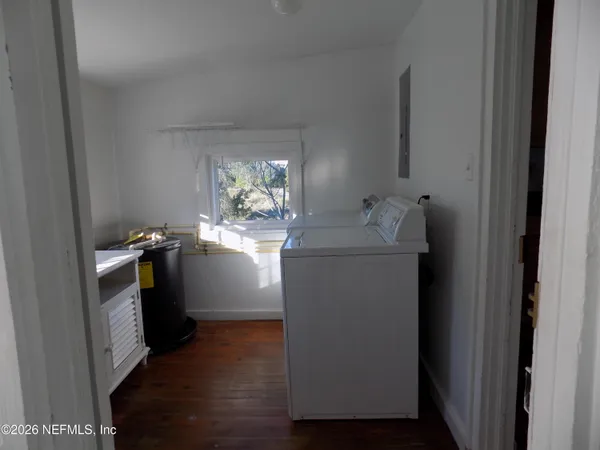 a utility room with cabinets washer and dryer